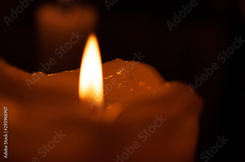 One candle flame at night closeup - isolated, macro