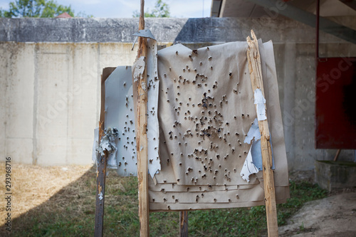 Shooting target full of bullet holes.
