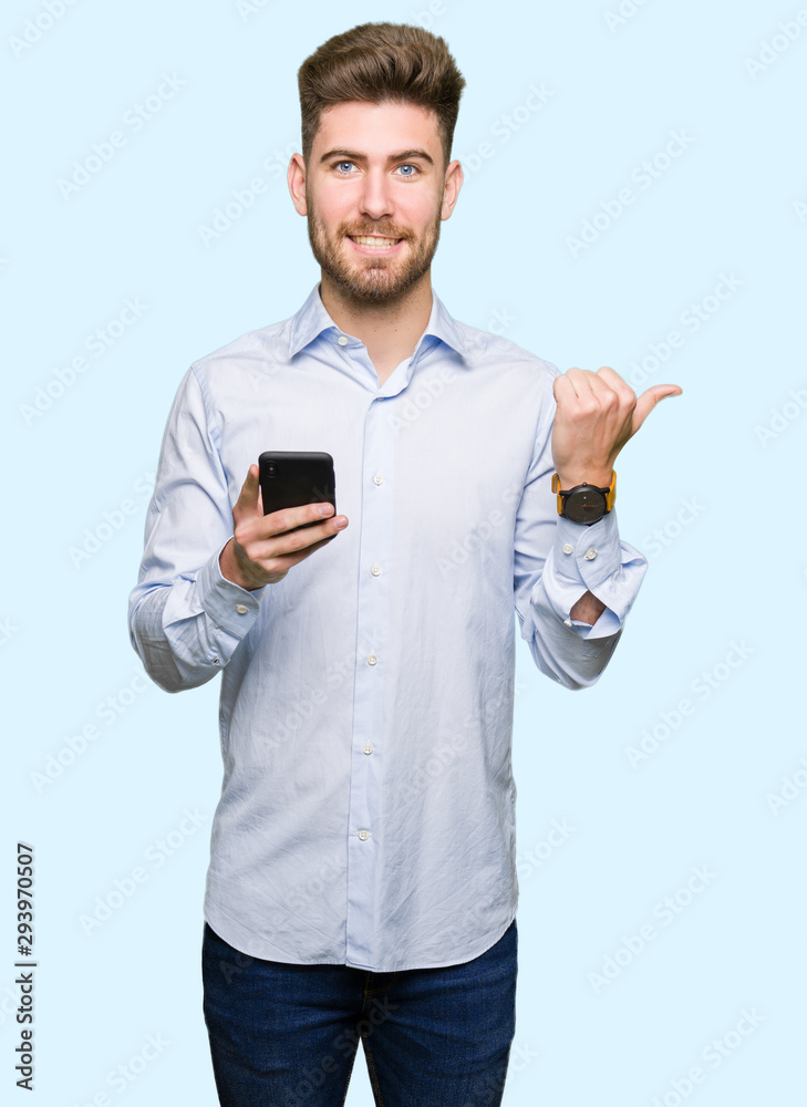 Young handsome man business using smartphone pointing and showing with thumb up to the side with happy face smiling Young handsome man business using smartphone pointing and showing with thumb up to the side with happy face smiling