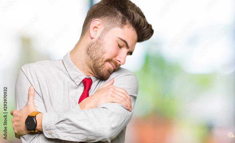 Young handsome business man Hugging oneself happy and positive, smiling confident. Self love and self care Young handsome business man Hugging oneself happy and positive, smiling confident. Self love and self care