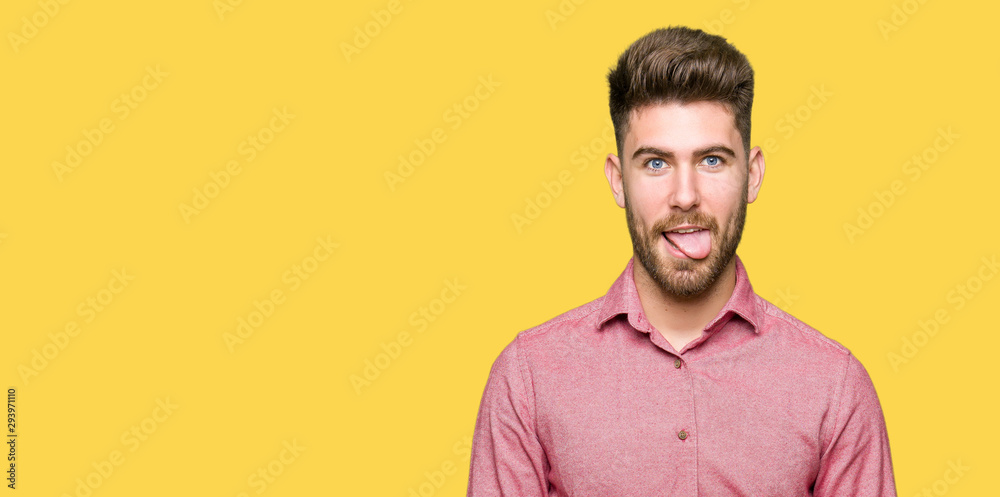 Young handsome business casual man sticking tongue out happy with funny expression. Emotion concept. Young handsome business casual man sticking tongue out happy with funny expression. Emotion concept.