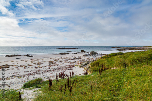 A sandy beach on the Hebridean island of North Uist, on a late summers day photo