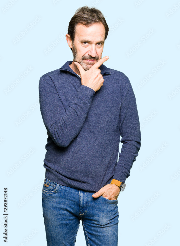 Middle age handsome man wearing a sweater looking confident at the camera with smile with crossed arms and hand raised on chin. Thinking positive. Middle age handsome man wearing a sweater looking confident at the camera with smile with crossed arms and hand raised on chin. Thinking positive.