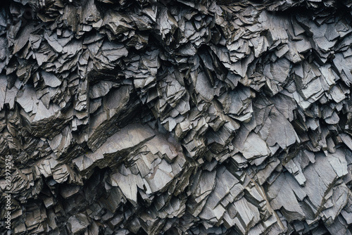 Basaltic rocks on the black sand beach photo