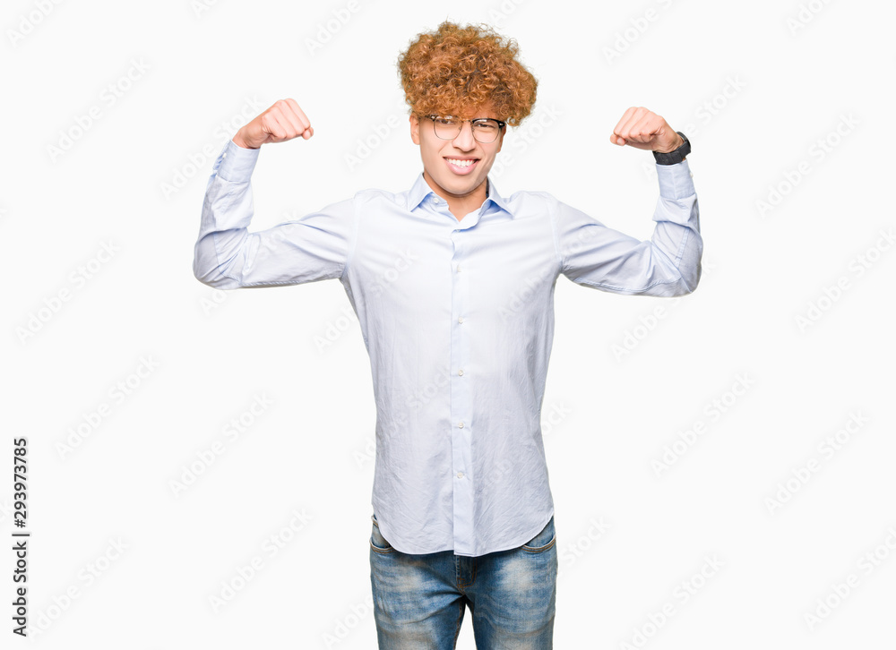 Young handsome business man with afro wearing glasses showing arms muscles smiling proud. Fitness concept. Young handsome business man with afro wearing glasses showing arms muscles smiling proud. Fitness concept.