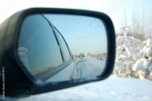 Reflection of truck in back wing mirror at winter road Tractor unit © Lunatishe