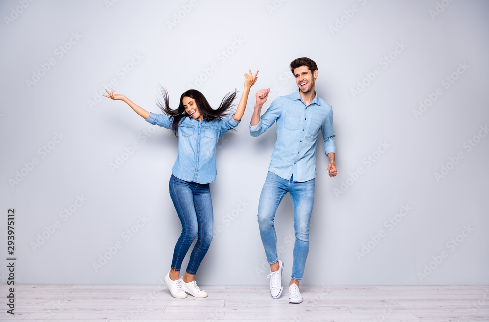 Full length photo of funny guy and lady chilling at disco party dancing throwing hair air wear casual jeans clothes isolated grey color background Full length photo of funny guy and lady chilling at disco party dancing throwing hair air wear casual jeans clothes isolated grey color background
