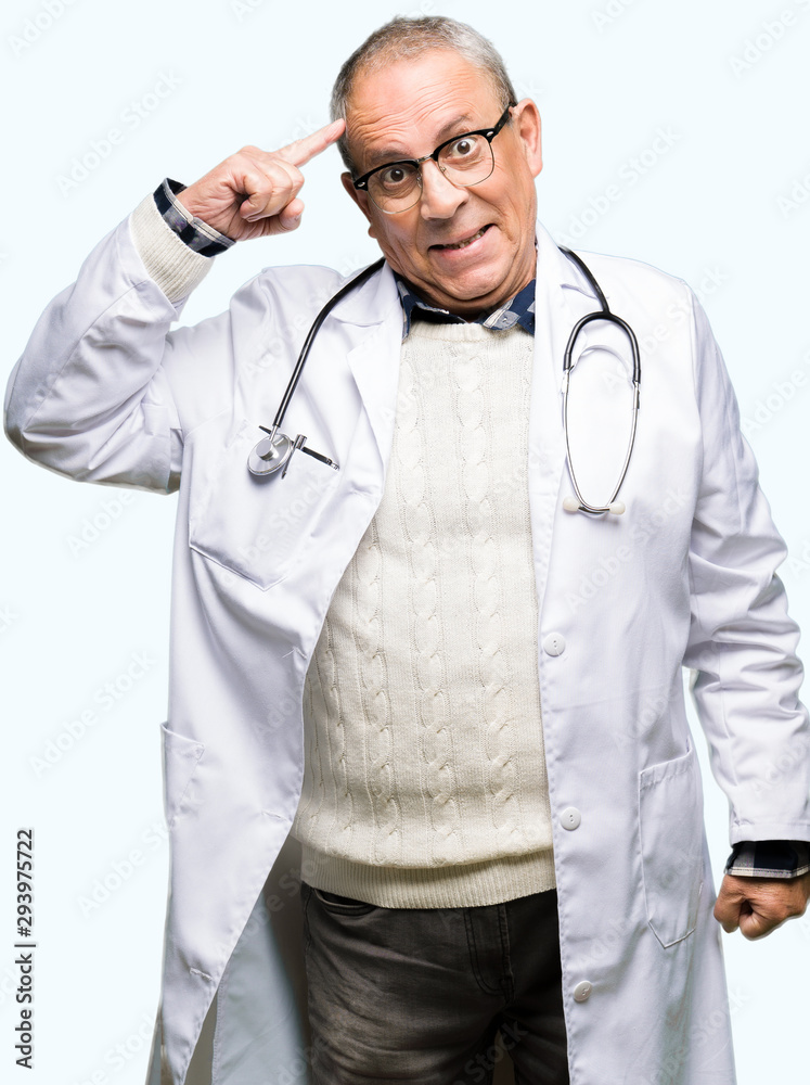 Handsome senior doctor man wearing medical coat Smiling pointing to head with one finger, great idea or thought, good memory Handsome senior doctor man wearing medical coat Smiling pointing to head with one finger, great idea or thought, good memory