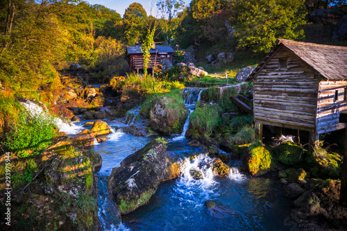 Small wooden houses by the river on popular picnic place Krupa na Vrbasu near the Banja Luka in Bosnia and Herzegovina photo