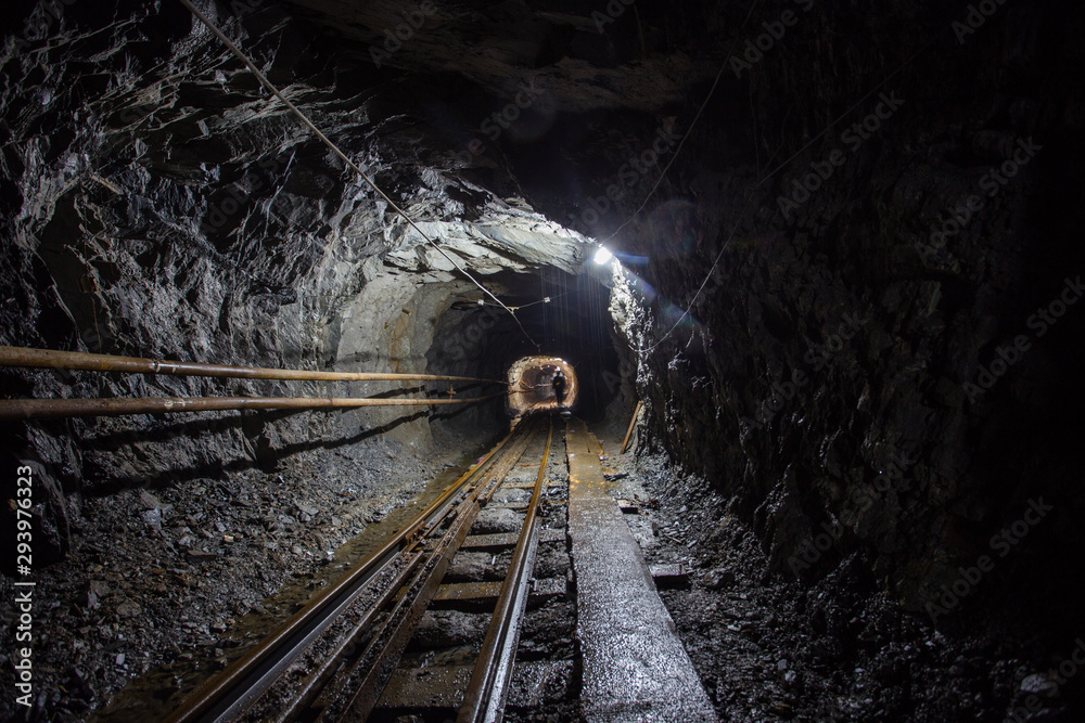 Naklejka premium Gold mine ore shaft tunnel with rails