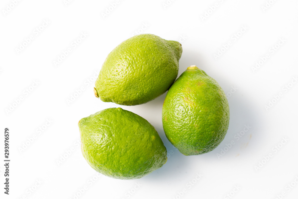 fresh green limes on a white background fresh green limes on a white background