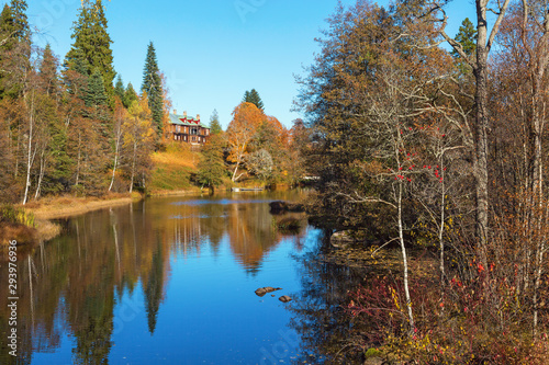 River in autumn colors with a manor house photo