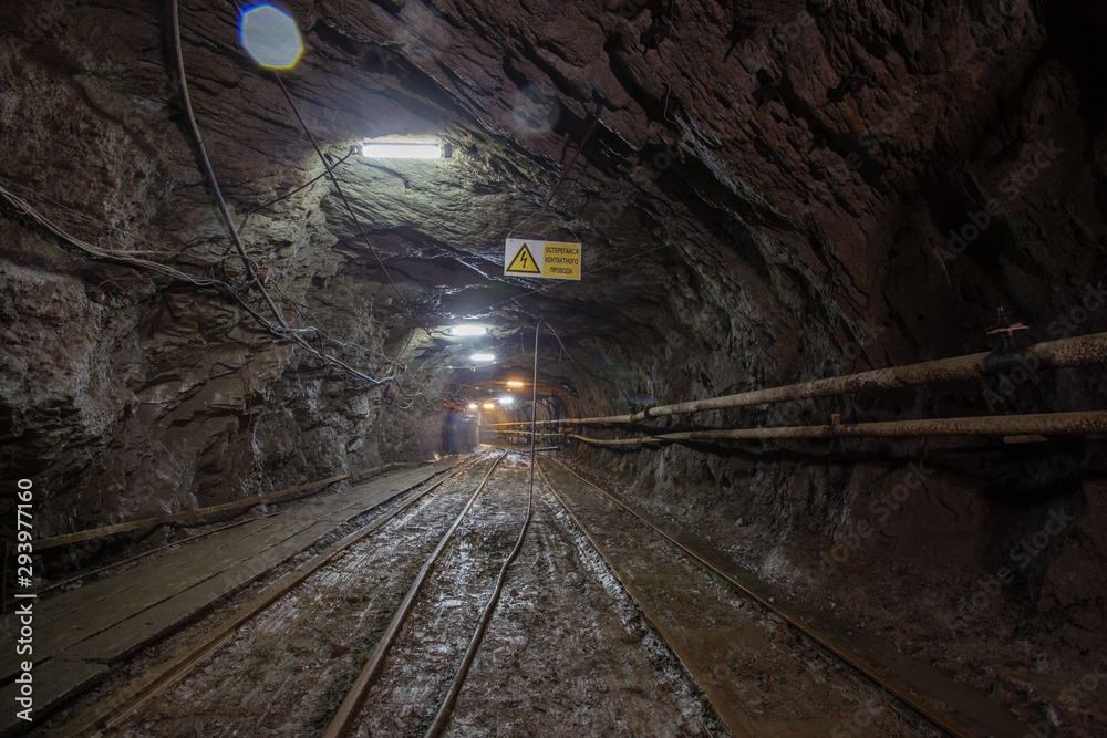 Fototapeta premium Gold mine ore shaft tunnel with rails
