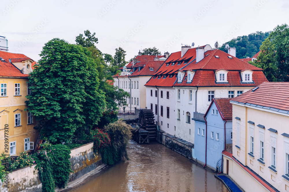 Obraz premium Historic water mill in Prague, water mill, Czech Republic. Old water mill at center of the Prague. Czechia. Mill Wheel of Velkoprevorsky Mill on Chertovka River in Prague, Czech Republic