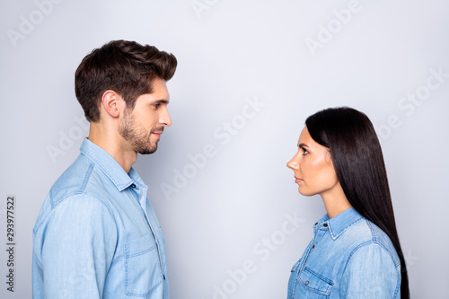 Close-up profile side view portrait of his he her she nice attractive charming lovely calm peaceful content couple looking at each other isolated over light white gray pastel color background