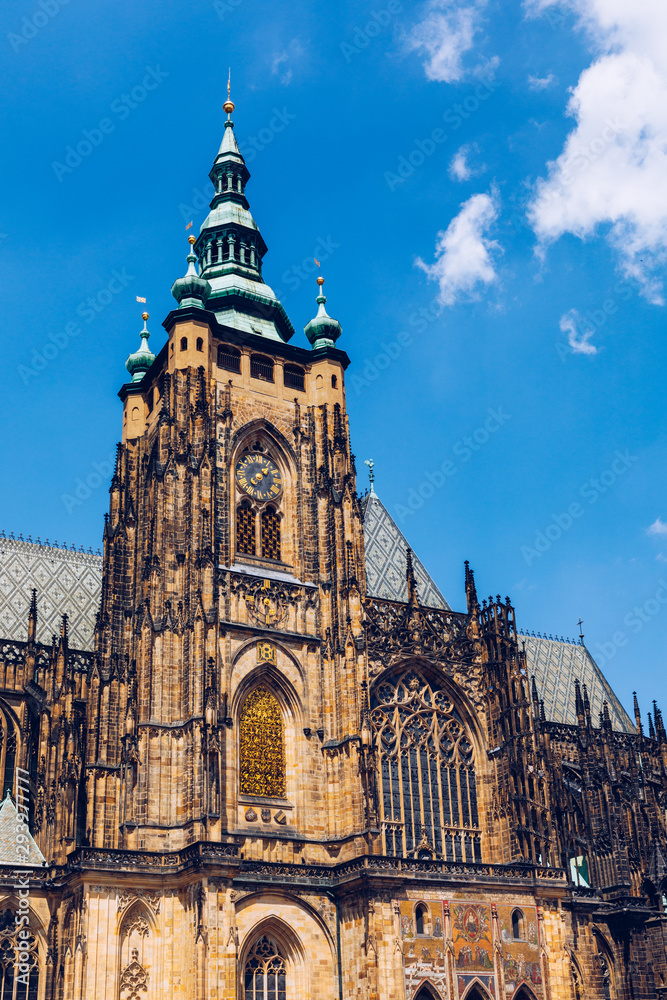 Fototapeta premium Prague, bell gothic towers and St. Vitus Cathedral. St. Vitus is a Roman Catholic cathedral in Prague, Czech Republic. Panoramic view from the courtyard to the south facade. Prague, Czechia.