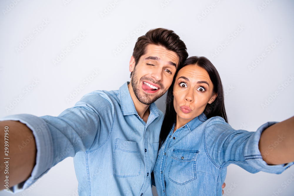 Self-portrait of his he her she nice attractive lovely cheerful cheery winsome couple grimacing fooling joking isolated over light white gray pastel color background Self-portrait of his he her she nice attractive lovely cheerful cheery winsome couple grimacing fooling joking isolated over light white gray pastel color background