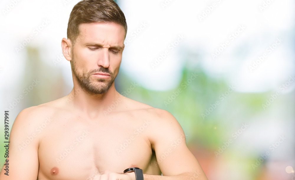 Foto de Handsome shirtless man showing nude chest Checking the time on  wrist watch, relaxed and confident do Stock