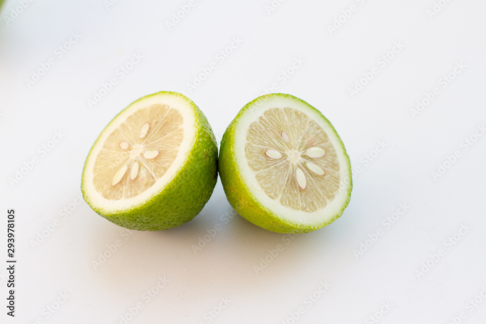 halves of green lime on a white background halves of green lime on a white background