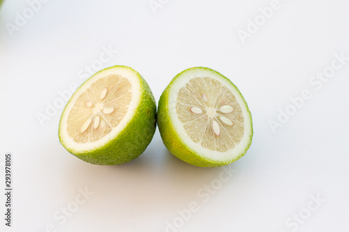 halves of green lime on a white background