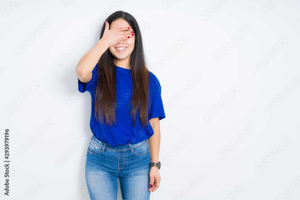 Beautiful brunette woman over isolated background smiling and laughing with hand on face covering eyes for surprise. Blind concept. Beautiful brunette woman over isolated background smiling and laughing with hand on face covering eyes for surprise. Blind concept.