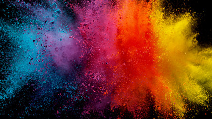 Explosion of colored powder on black background