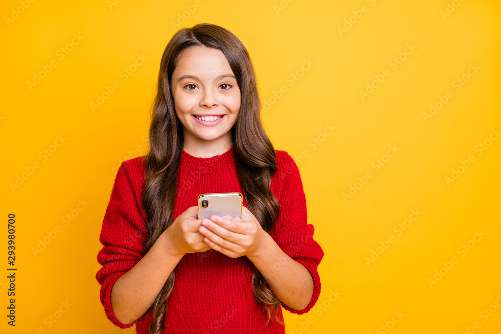 Portrait of positive sweet wavy hair child hold her cellphone true addicted blogger multimedia user share comment posts wear style stylish trendy pullover isolated bright color background Portrait of positive sweet wavy hair child hold her cellphone true addicted blogger multimedia user share comment posts wear style stylish trendy pullover isolated bright color background