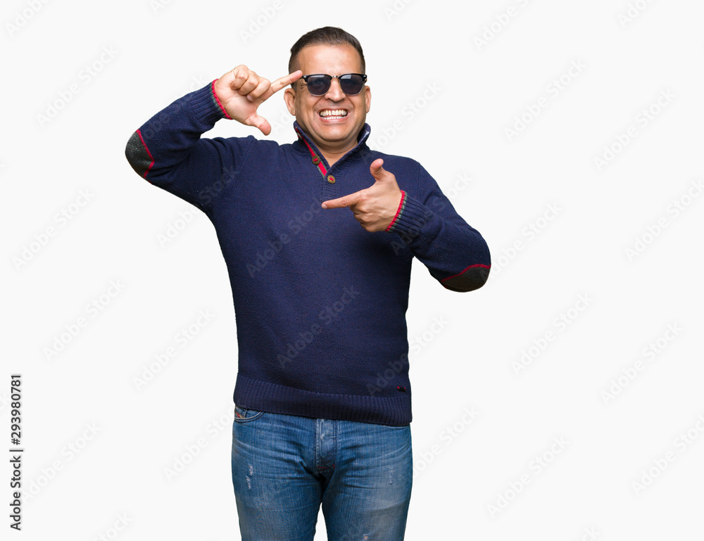 Middle age arab man wearing sunglasses over isolated background smiling making frame with hands and fingers with happy face. Creativity and photography concept. Middle age arab man wearing sunglasses over isolated background smiling making frame with hands and fingers with happy face. Creativity and photography concept.