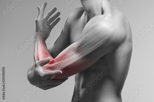 Man holds his elbow by the hand. Pain zone in the arm and bone illustration photo