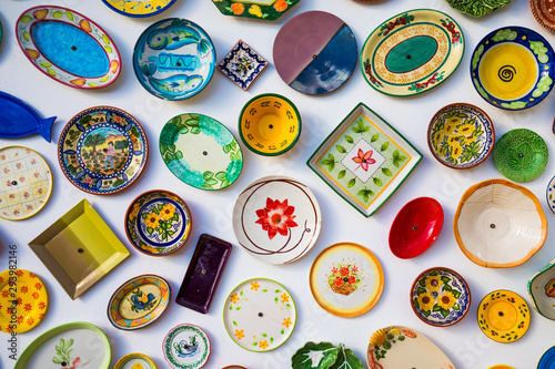 Collection of colorful Portuguese ceramic pottery, local craft products from Portugal. Ceramic plates display in Portugal. Colorful of vintage ceramic plates in Sagres, Portugal.