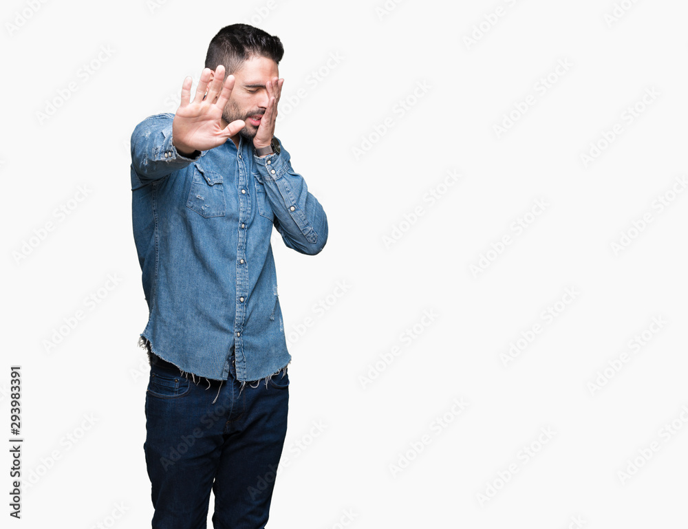 Young handsome man over isolated background covering eyes with hands and doing stop gesture with sad and fear expression. Embarrassed and negative concept. Young handsome man over isolated background covering eyes with hands and doing stop gesture with sad and fear expression. Embarrassed and negative concept.