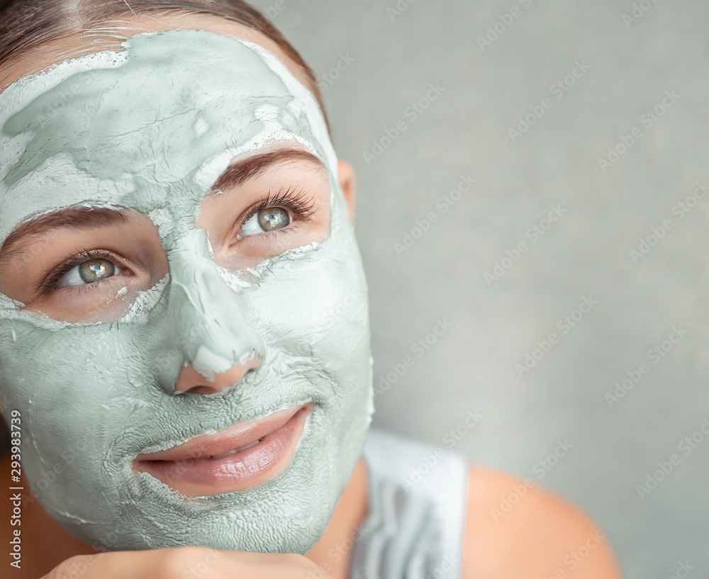 Beautiful girl doing facial mask Beautiful girl doing facial mask
