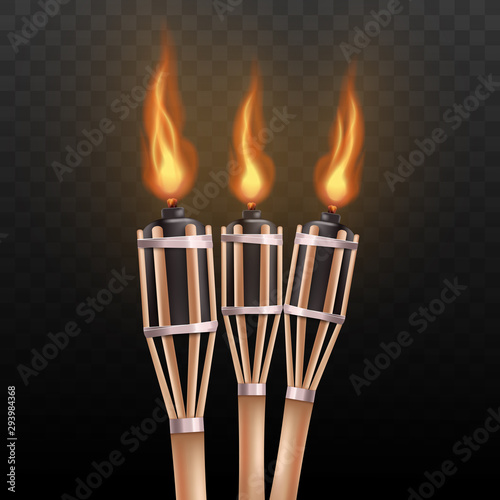 Realistic burning tiki torch set isolated on dark transparent background photo