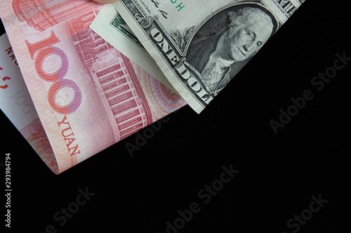 dollar and yuan on a black background with space for test