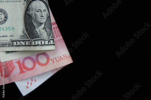 dollar and yuan on a black background with space for test