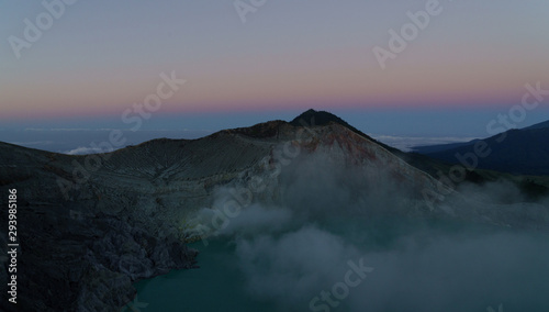 First light with fog. Sunrise on on the mountain  Ijen  Java  Indonesia.
