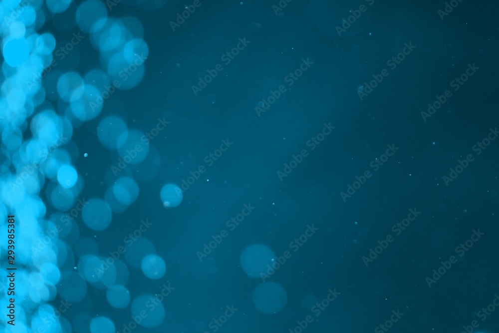 light blue brilliant lights one side frame bokeh texture - fantastic abstract photo background