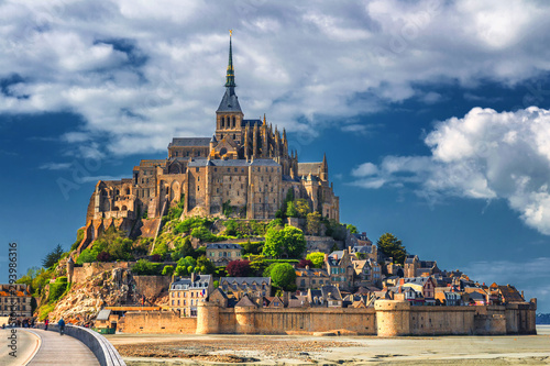 Beautiful panoramic view of famous Le Mont Saint-Michel tidal island with blue sky. Normandy, northern France