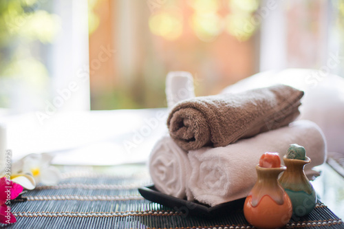 Fototapeta Naklejka Na Ścianę i Meble -   Spa treatments on White spa massage bed with candles, massage oil and Herbal massage cubes