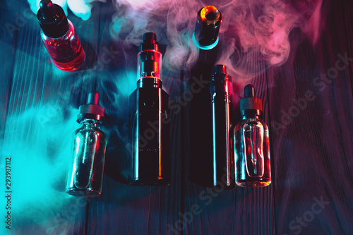 vaping device mod and vaping staff on dark background