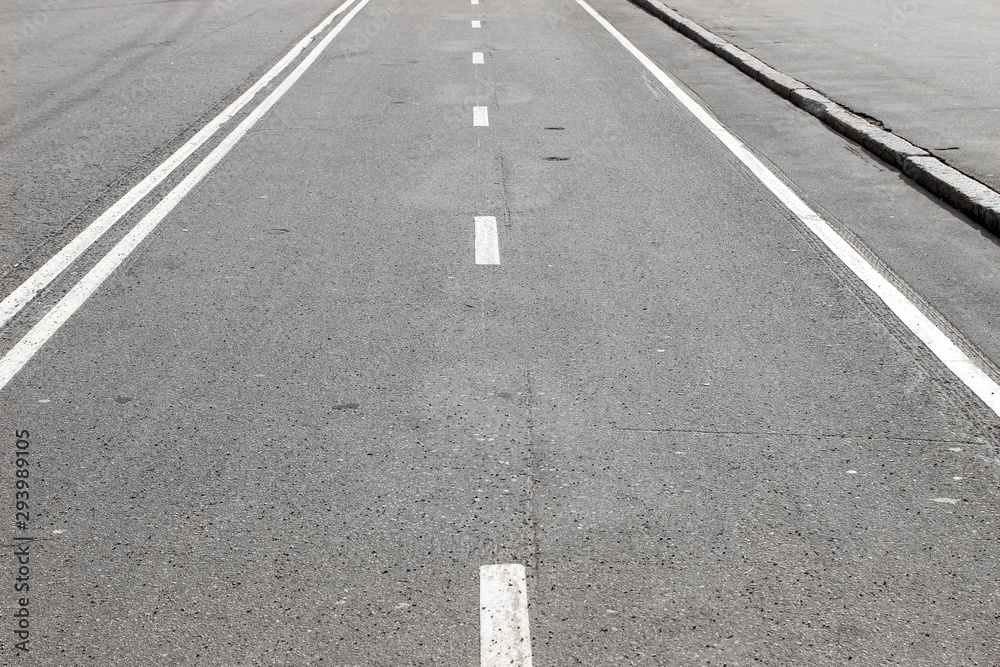 An empty road with white road marking An empty road with white road marking