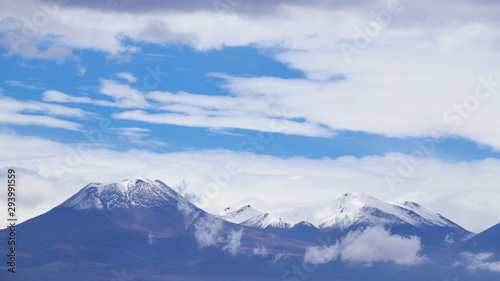 Fototapeta Naklejka Na Ścianę i Meble -  View of the Andean volcanoes covered by clouds, Atacama Desert, Chile