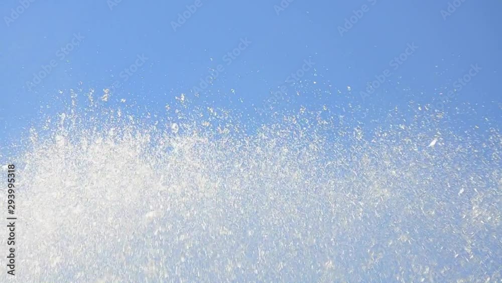 Sparkling water splashes and drops in sunlight over mountain waterfall, creek Sparkling water splashes and drops in sunlight over mountain waterfall, creek