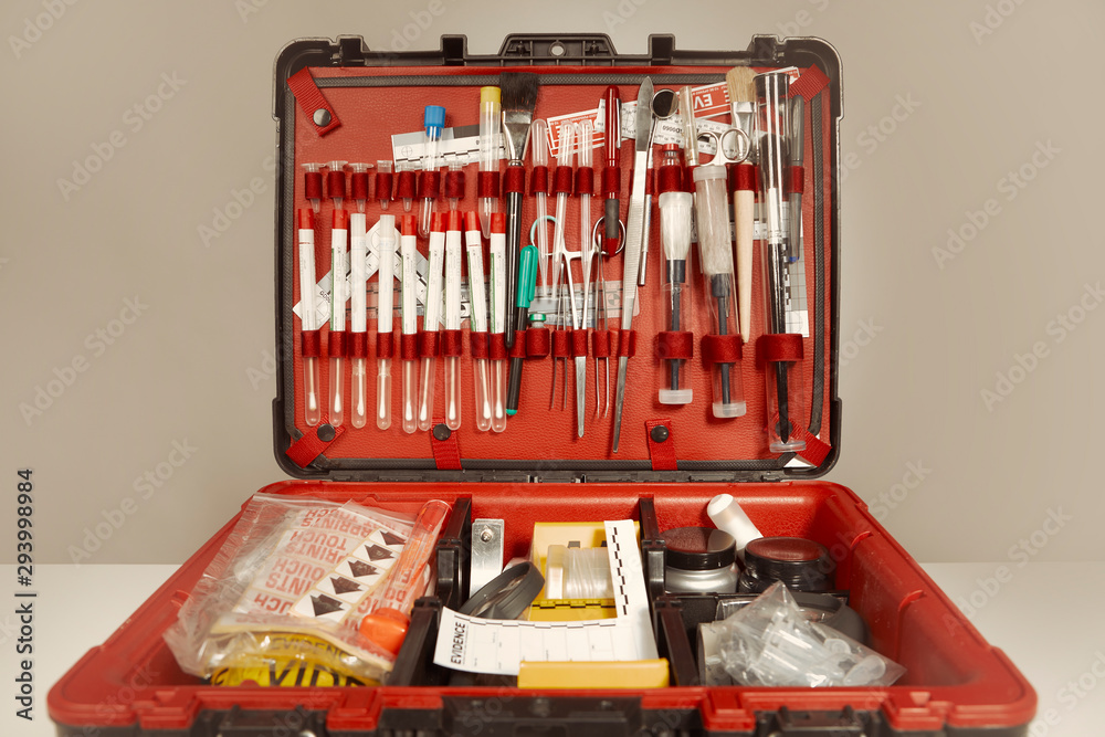 Suitcase of criminologist technician with many tools of evidence collecting Suitcase of criminologist technician with many tools of evidence collecting