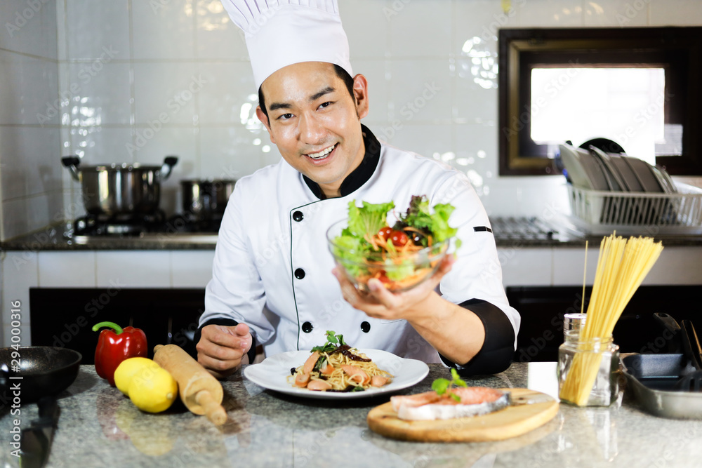 Asian Man Chef cooking food in restuarant Asian Man Chef cooking food in restuarant