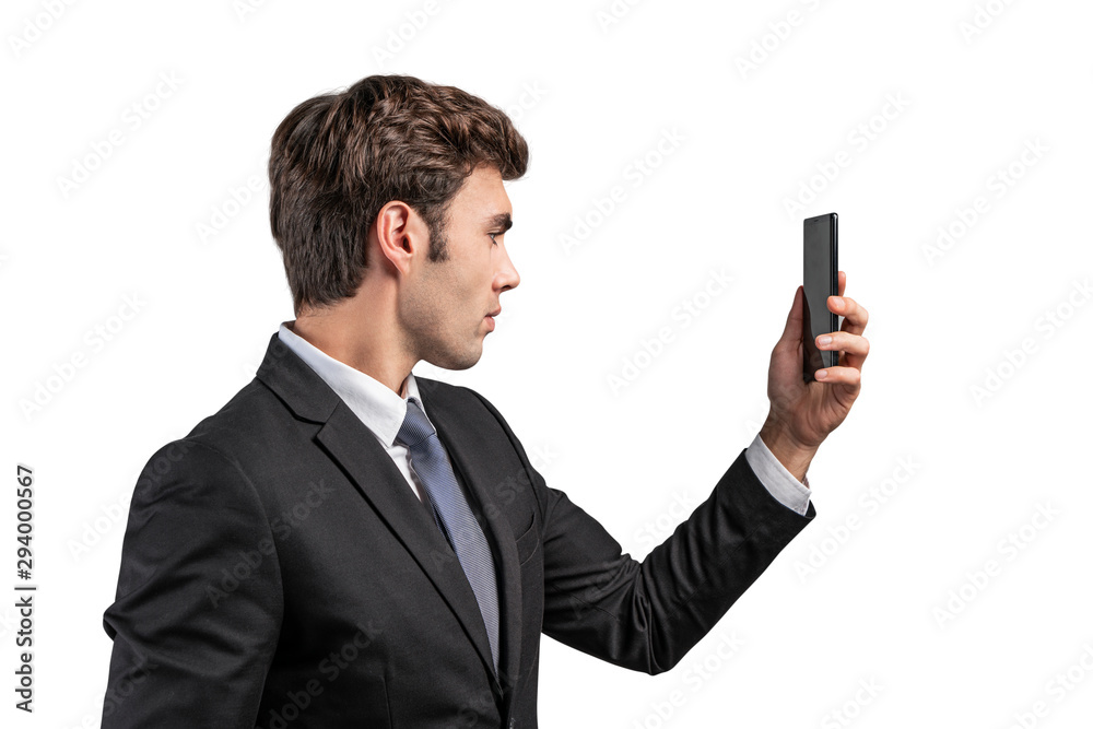 Handsome businessman looking at phone, isolated Handsome businessman looking at phone, isolated