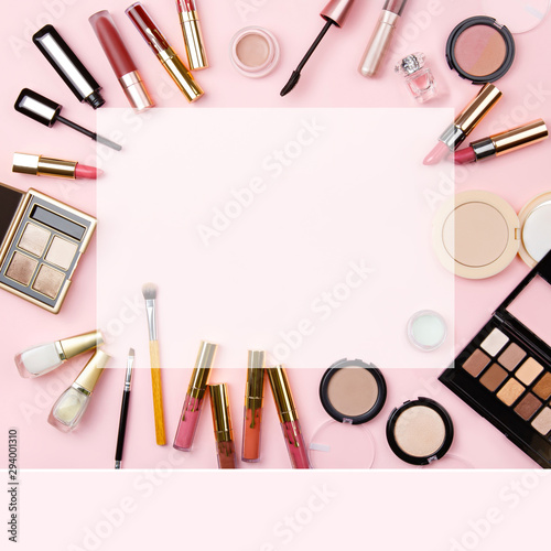 Background of woman cosmetics for social media on pink. Decorative cosmetics: highlighter, concealer, rouge, palette with eye shadows and brushes for face make up, face sculpture . Make up. Copy space
