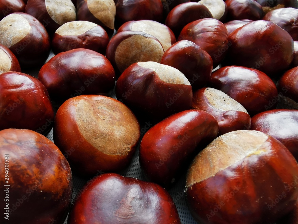 Ripe chestnuts close up, top view. Food background. Raw Chestnuts Ripe chestnuts close up, top view. Food background. Raw Chestnuts