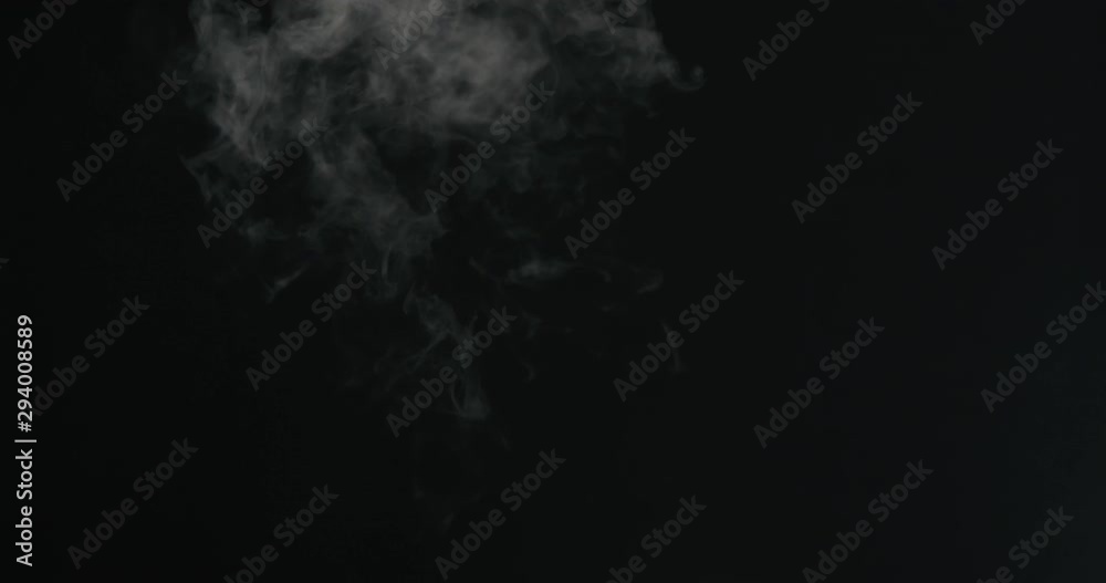 Slow motion water mist puff stream over black background