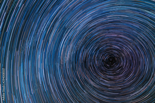 Beautiful starry sky with star trails orientation on the north star. Space background.